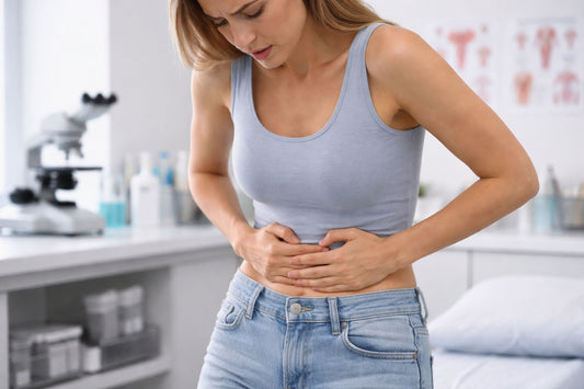 Woman holding lower abdomen due to chronic pelvic pain